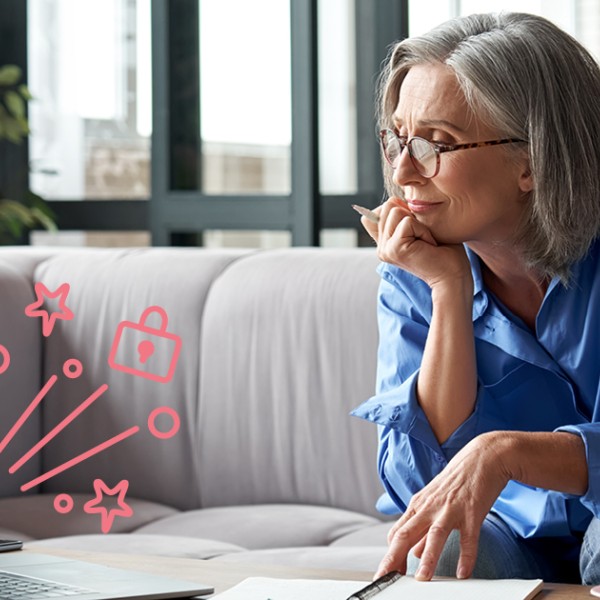 Femme assise sur le canapé devant son ordinateur portable.